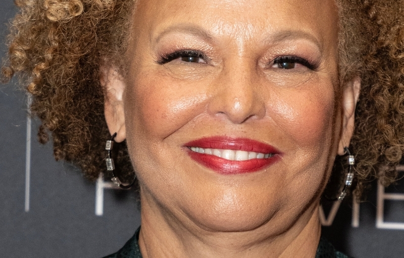 A close up photo of a light-skinned Black woman wearing red lipstick