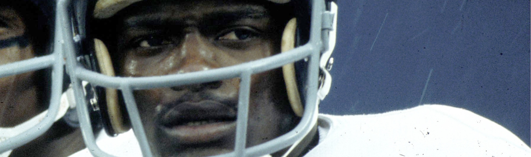 A Black man wearing a football helmet